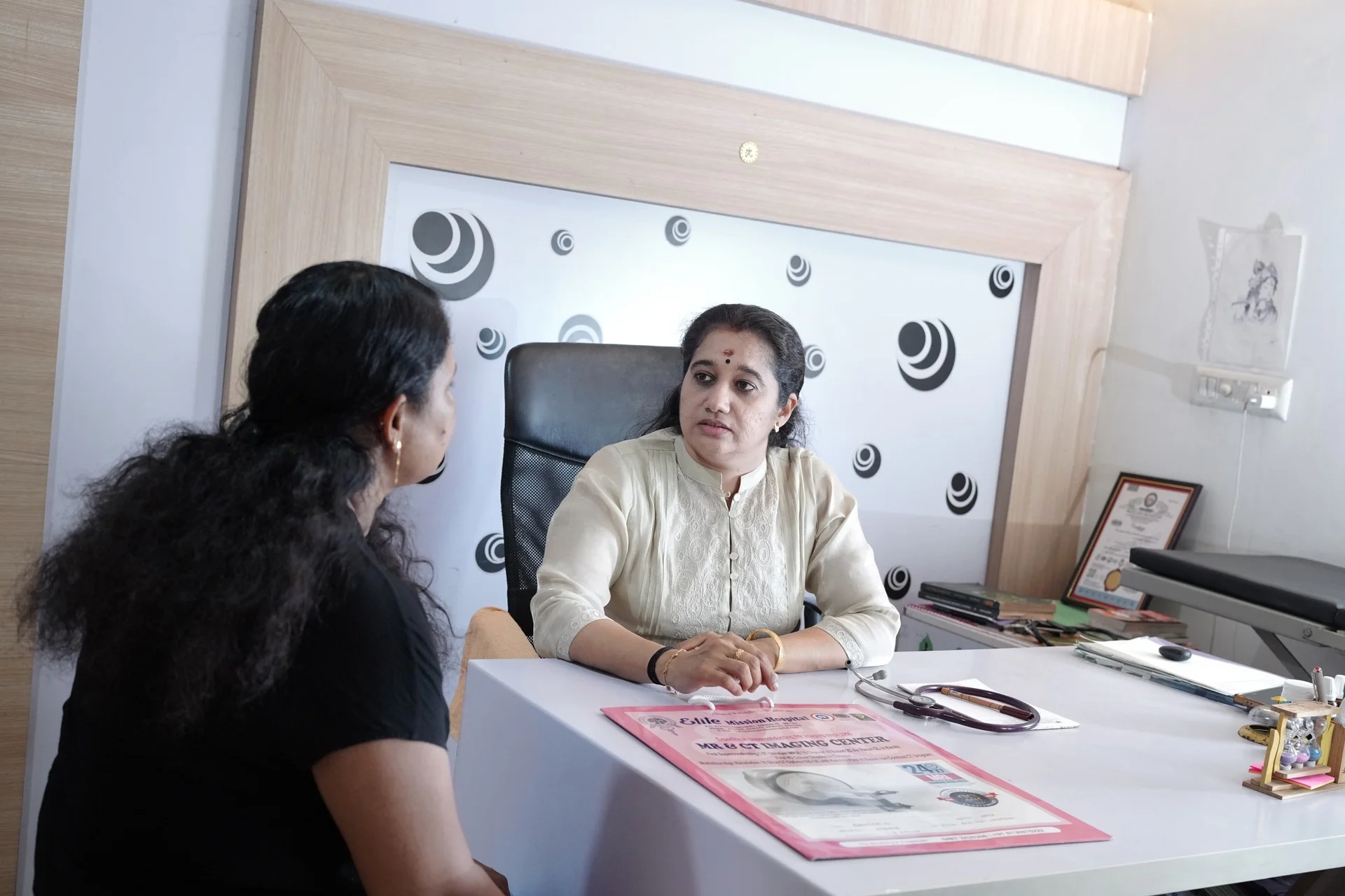 Dr. Sujithra conducting an Ayurvedic consultation with a patient